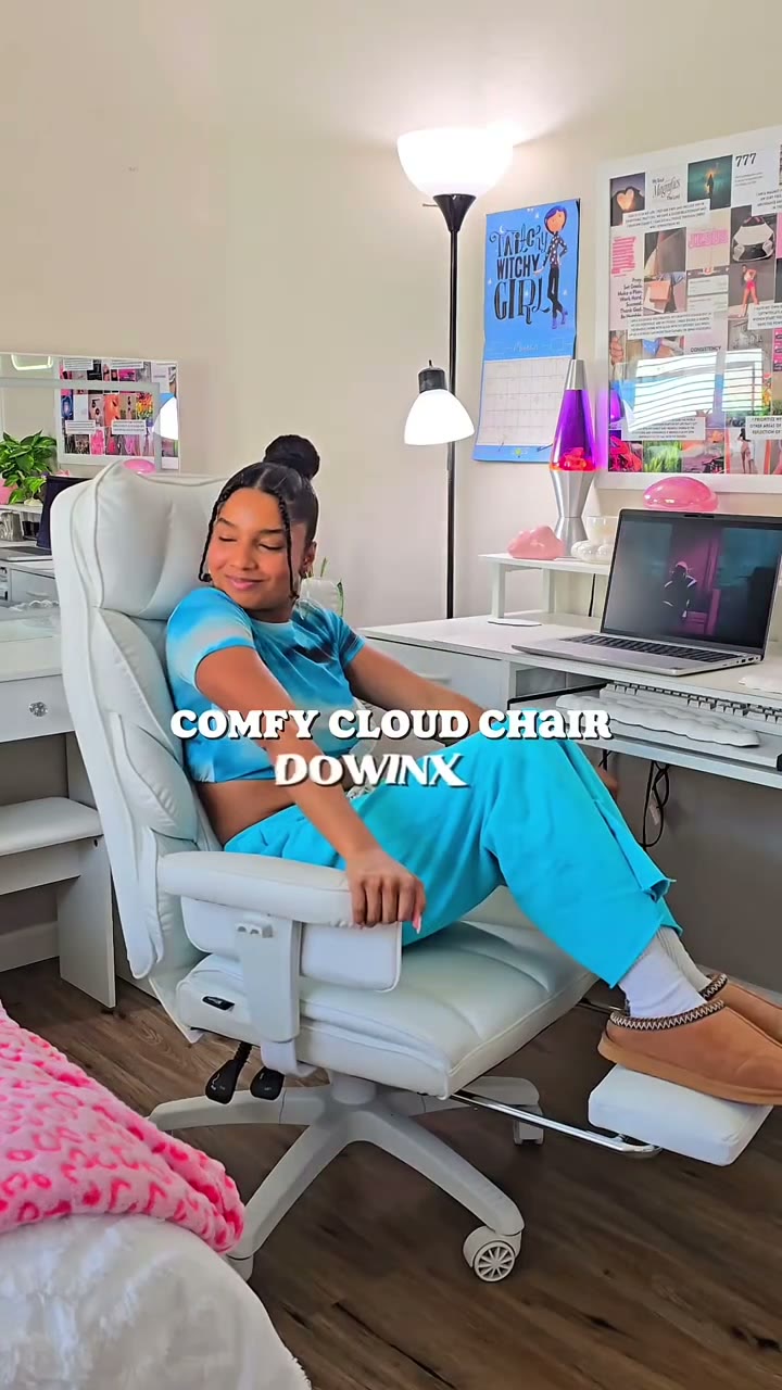 Layla reclining in a white ergonomic office chair at her pink and white desk