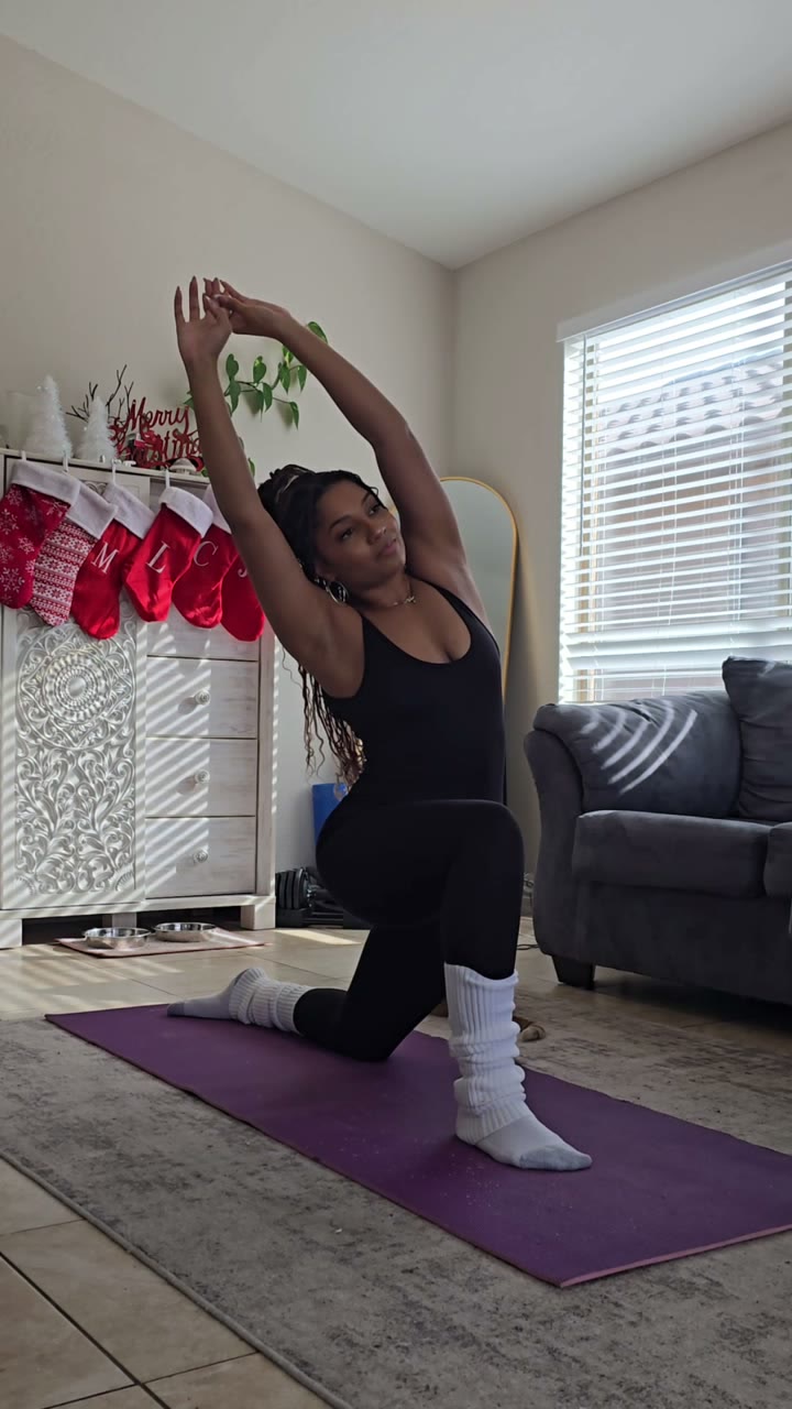 Layla stretching on a purple yoga mat at home